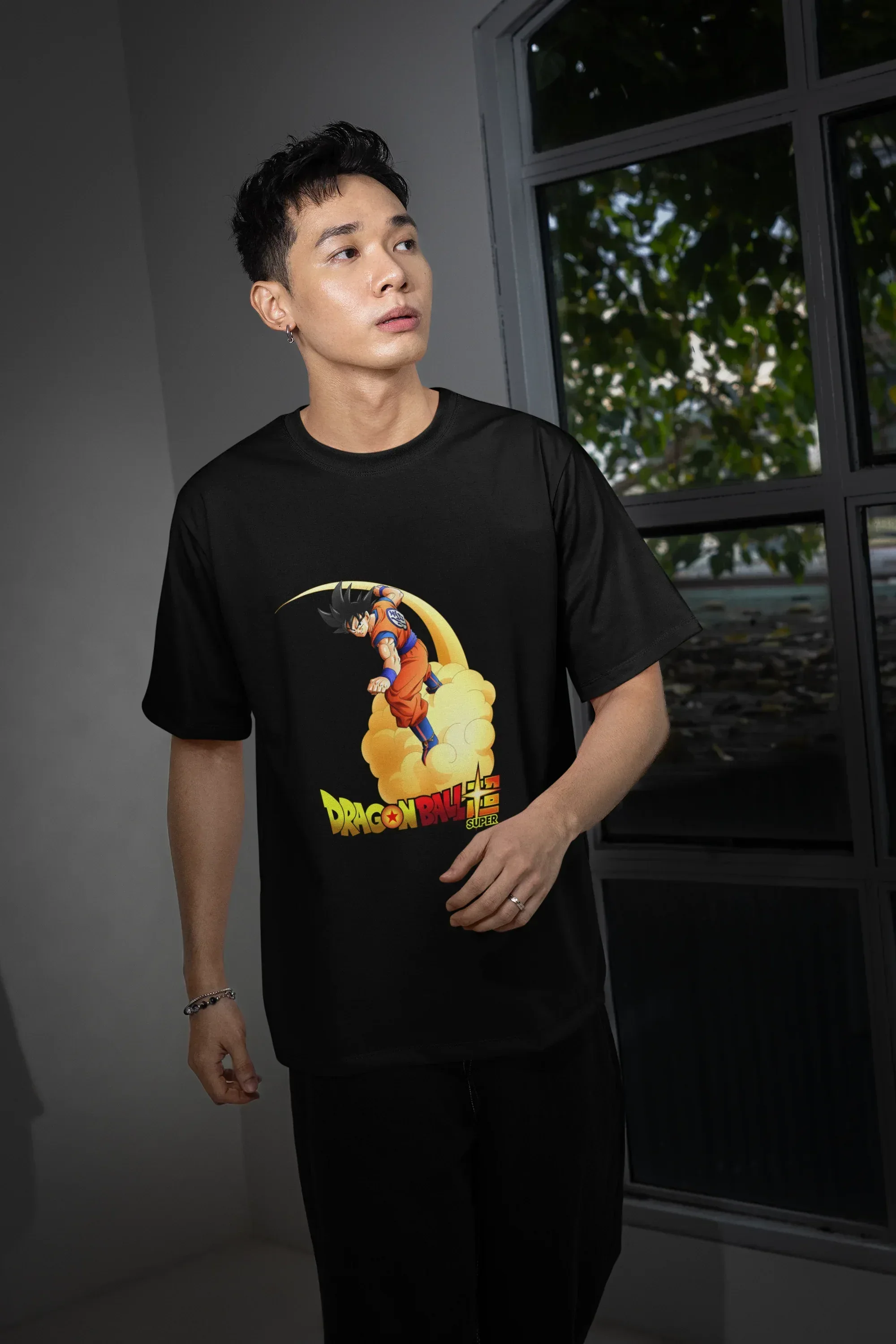 oversized-t-shirt-mockup-featuring-a-man-posing-with-a-serious-look-and-standing-near-a-window-m54148_3 - Drippyx