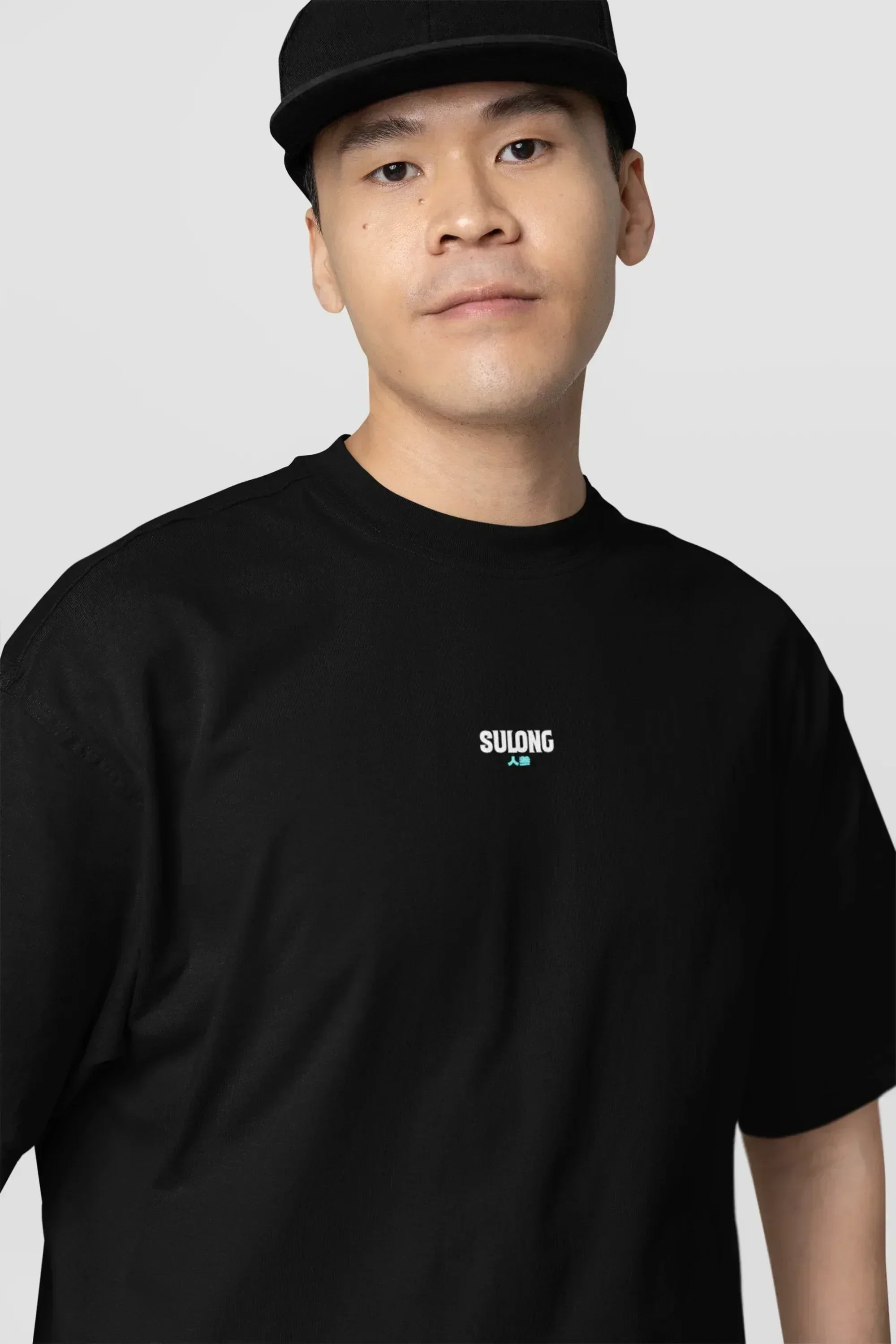 oversized-tee-mockup-of-a-serious-man-standing-against-a-customizable-background-m38927_2 - Drippyx